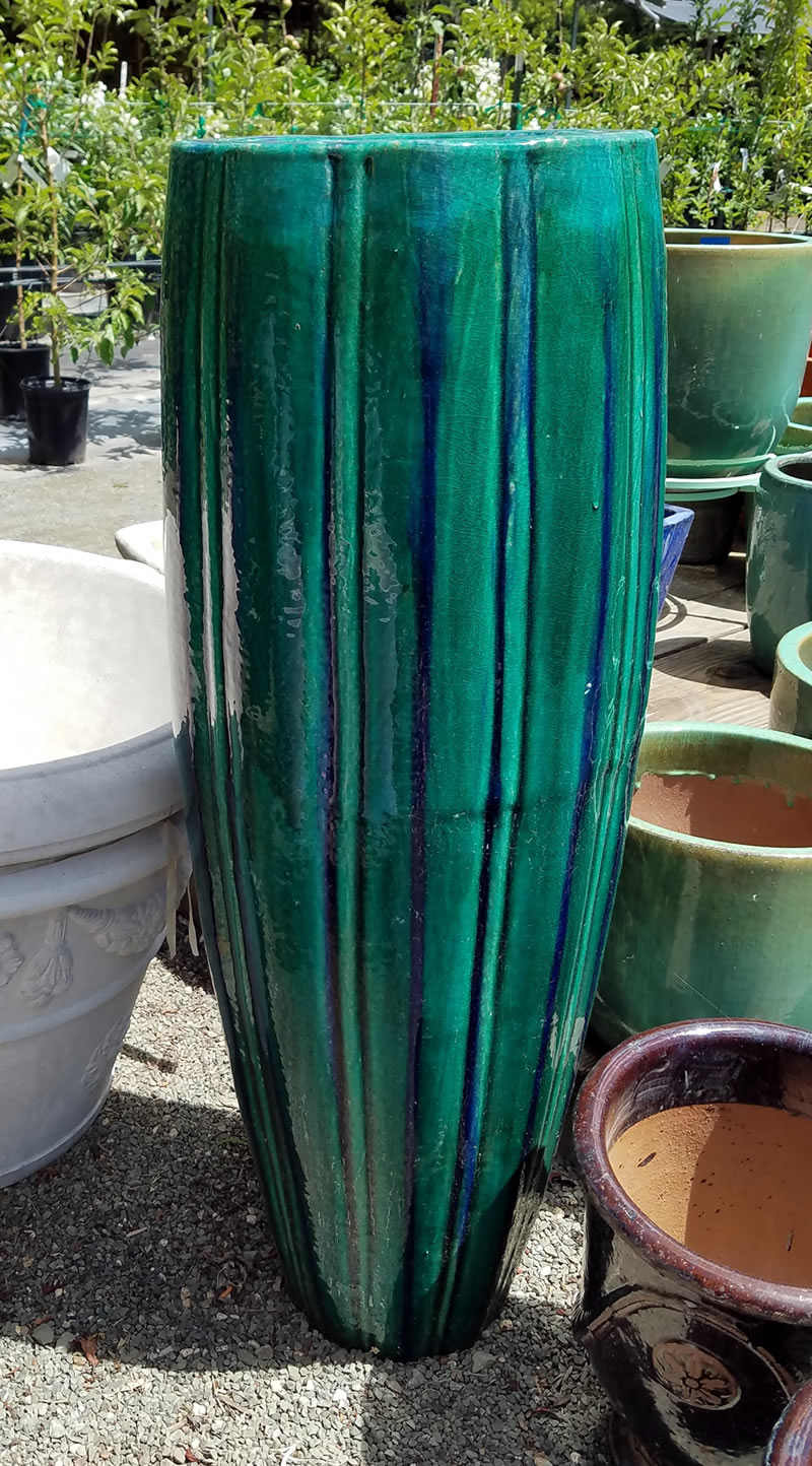 Tall blue container among shorter pots