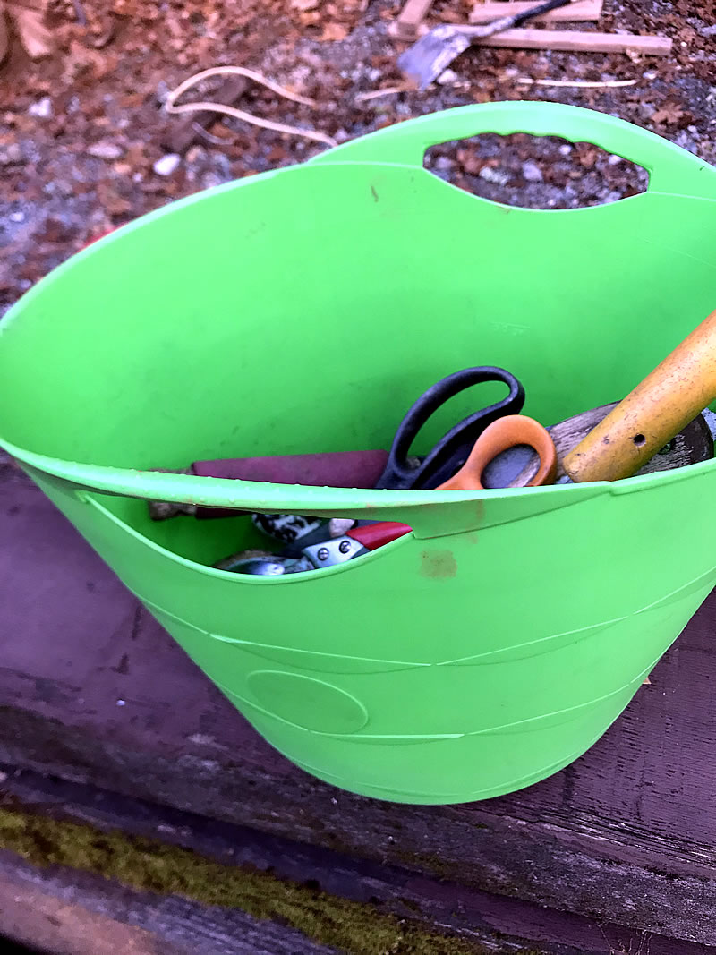 Green Tuff Tote full of garden hand tools