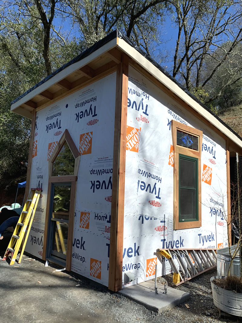 Half-built sturdy shed with window and sloping roof