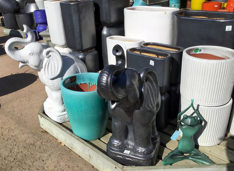 Empty plant containers on display including elephant shaped pots