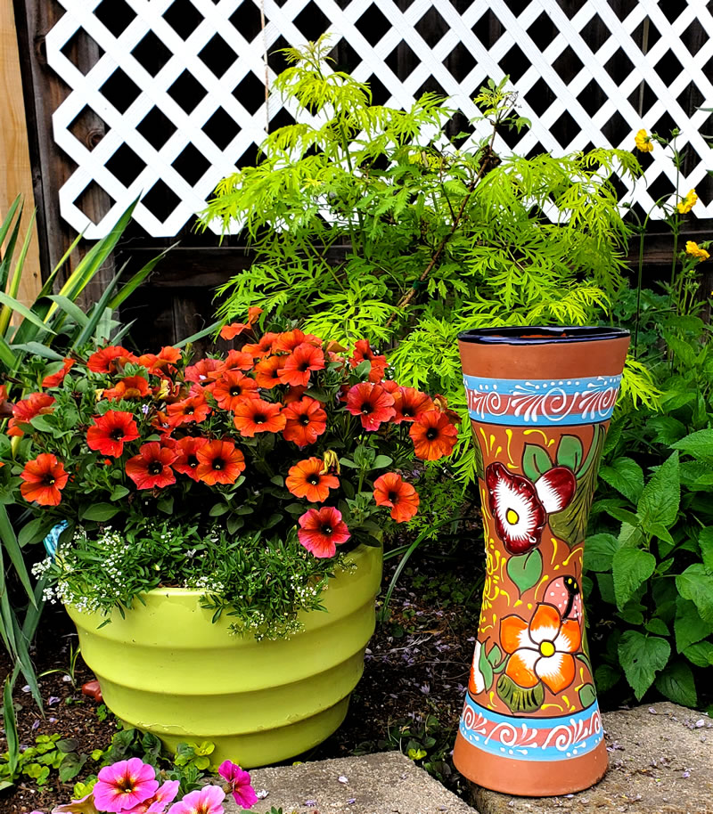 Two pots, round green and tall orange flowered