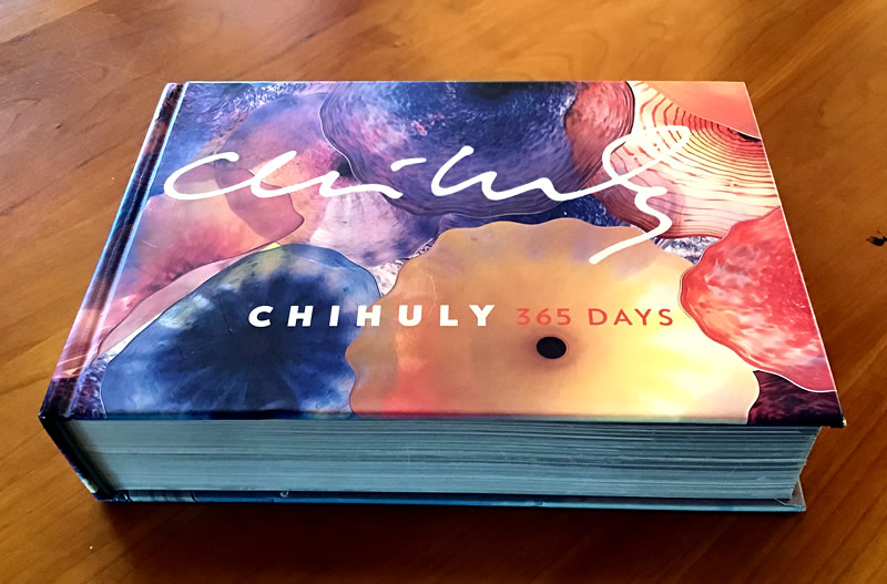 Chihuly Artbook on wood tabletop.