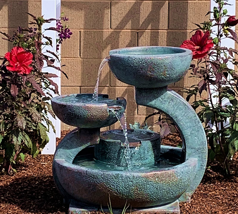 Hibiscus plants on either side of fountain.