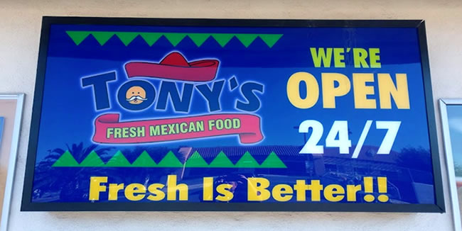 Sign on front of building, Tony's Fresh Mexican Food open 24/7