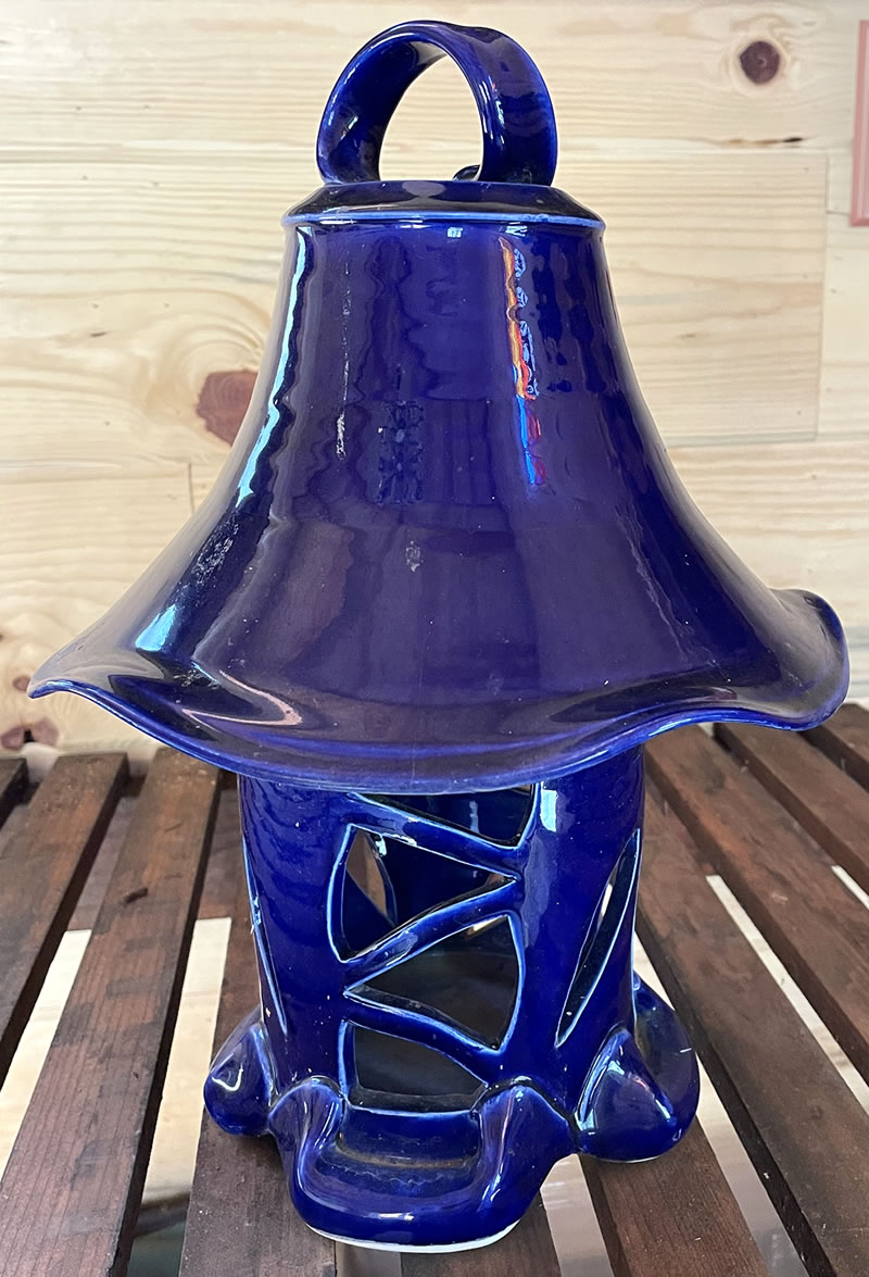 Cylindrical blue ceramic lantern with lampshade shaped hood.
